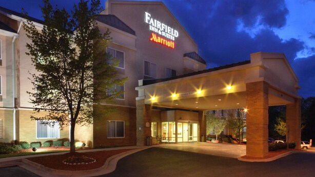A Fairfield Inn & Suites Marriott hotel entrance at dusk with a well-lit facade and a landscaped front yard. - Fairfield by Marriott Inn & Suites Richmond Innsbrook (Richmond)