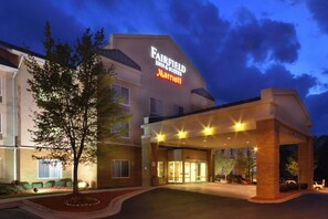 A Fairfield Inn & Suites Marriott hotel entrance at dusk with a well-lit facade and a landscaped front yard. - Fairfield by Marriott Inn & Suites Richmond Innsbrook (Richmond)