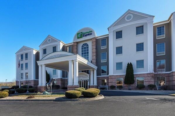 A Holiday Inn Express hotel with a central entrance, multiple windows, and a brick facade.