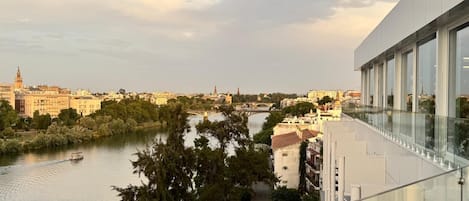 A river with a bridge, buildings, and trees.