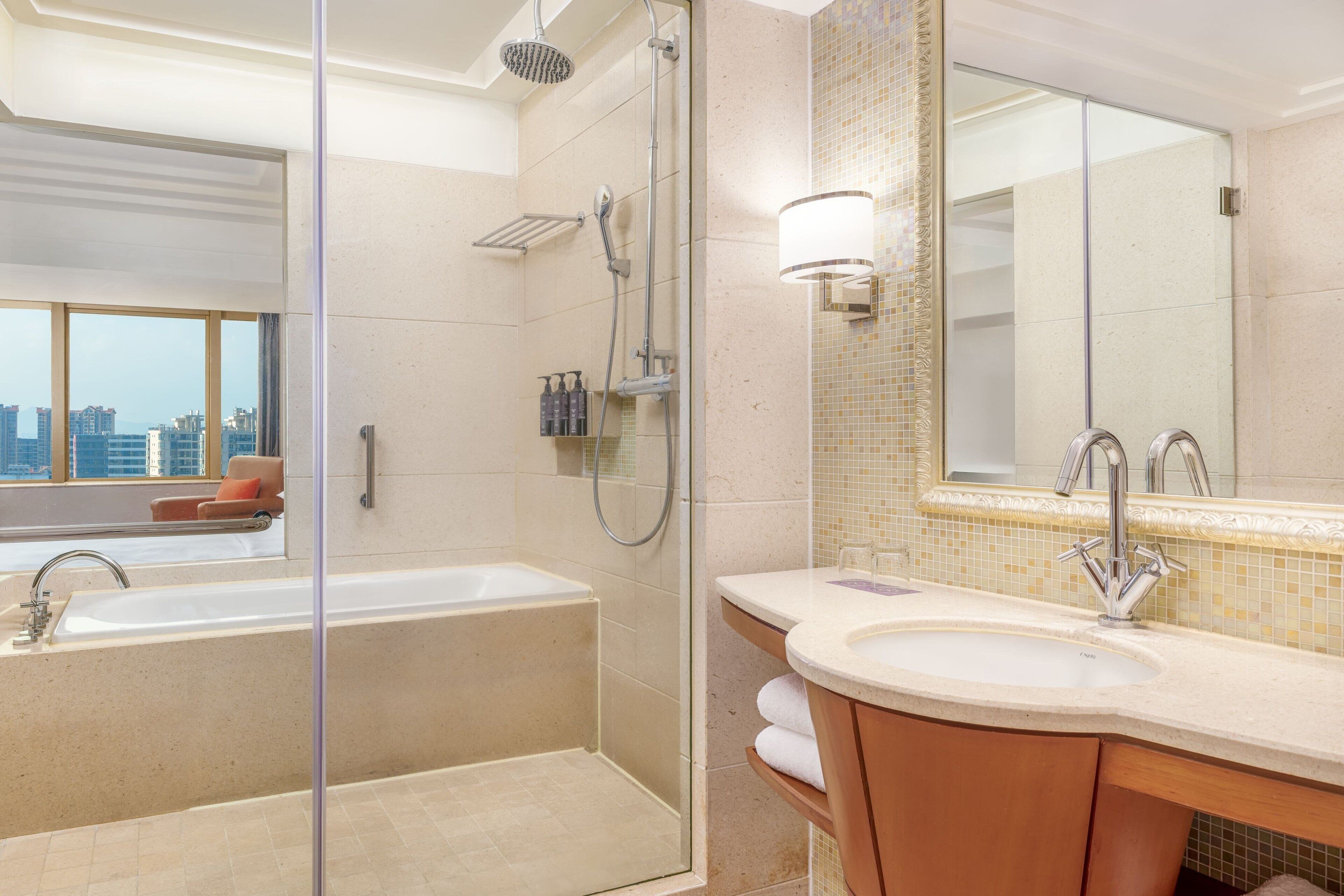 A modern bathroom with a bathtub, shower, and vanity.