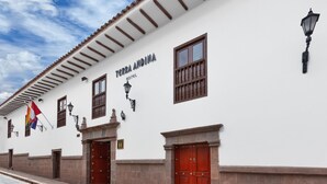 A white building with a sign reading "TERRA ANDINA HOTEL". - Terra Andina Colonial Mansion (Cusco)