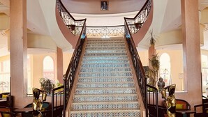 A grand staircase with ornate railings and patterned steps, leading to an upper floor. - Hotel Idou Tiznit (Tiznit)