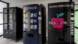 Three vending machines: a Pepsi machine, a natural spring water machine, and a vending machine with a sticker that says "Energy Zone". - Quality Inn Emporia (Emporia)
