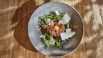 A plate of food on a wooden table.