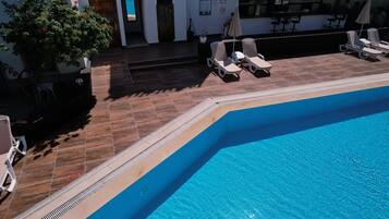 Outdoor pool, open 8:00 AM to 7:00 PM, pool umbrellas, pool loungers