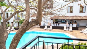 A pool area with lounge chairs and a bar. - Flora Hotel Bodrum  (Bodrum)