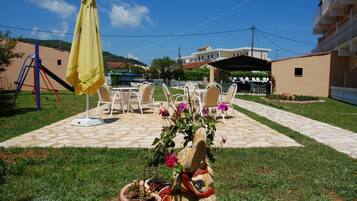 Relax in a serene outdoor space with a seating area, umbrella, and decorative touches.