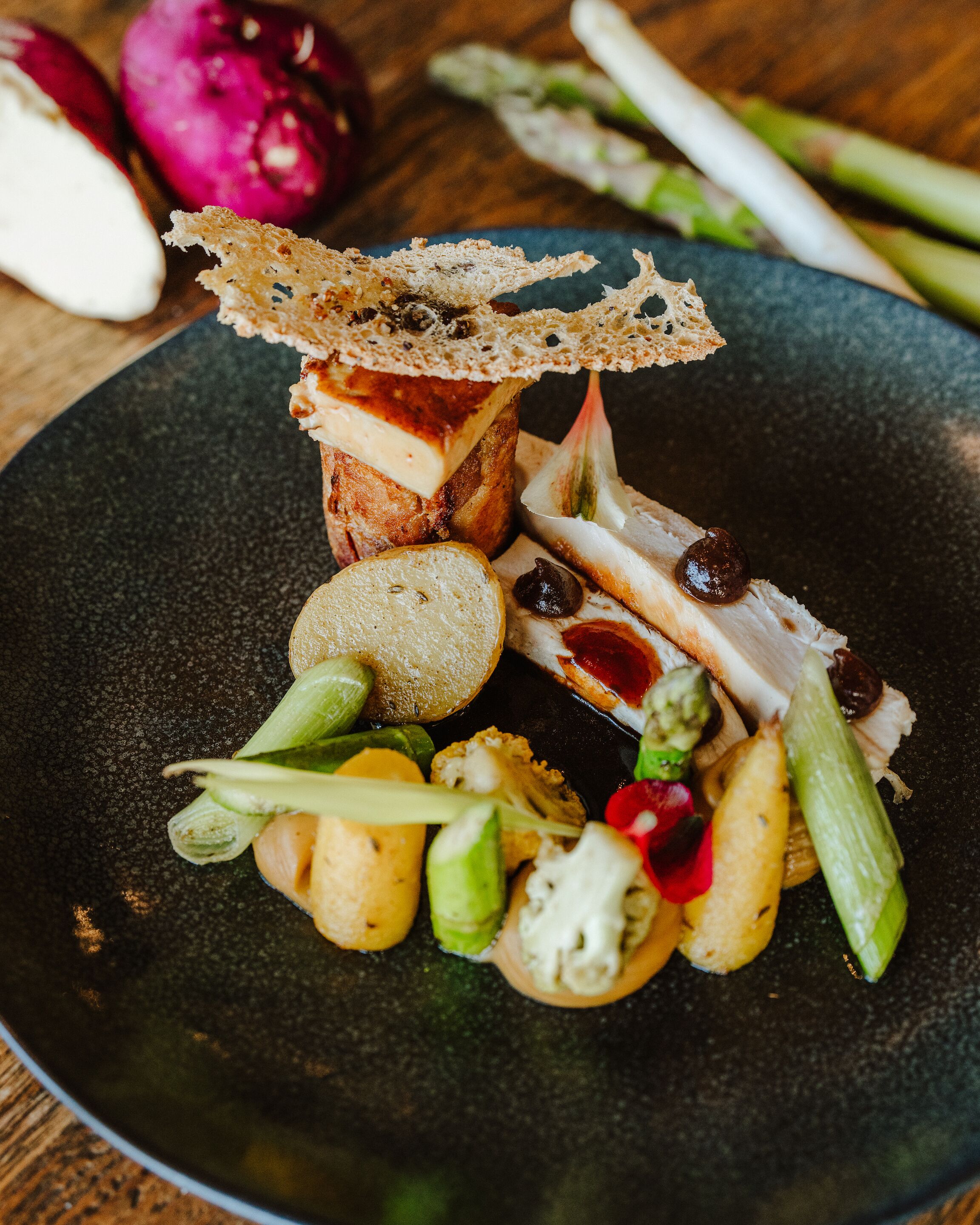 A plate with various food items including bread, cheese, and vegetables.