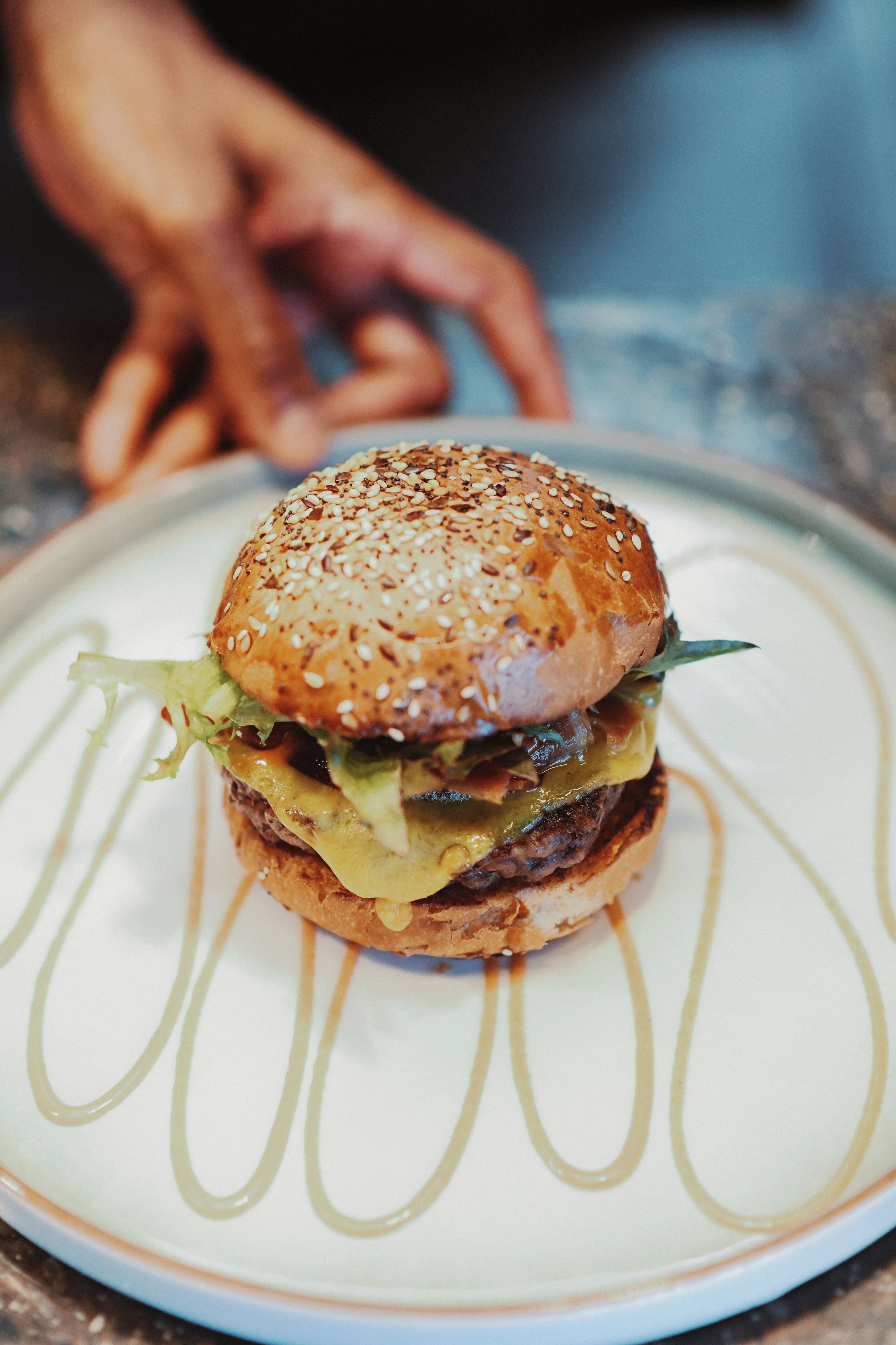 A sandwich on a plate with a decorative pattern.
