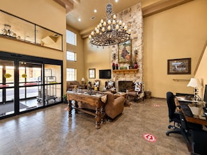 A spacious lobby with a fireplace, seating area, and a chandelier. - Velkommen Inn (Clifton)