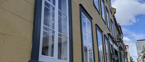 A building with multiple windows and a yellow facade.