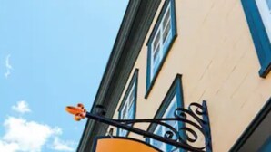 A hotel sign with a large 'A' and the name 'ATYPIO L'HÔTEL' in black letters on a yellow background. - Hôtel Atypiq (Québec City)