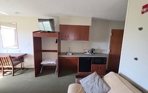 A compact living space with a kitchenette, a dining area, and a seating area. - Welcome Inn & Suites Tunica (Robinsonville)