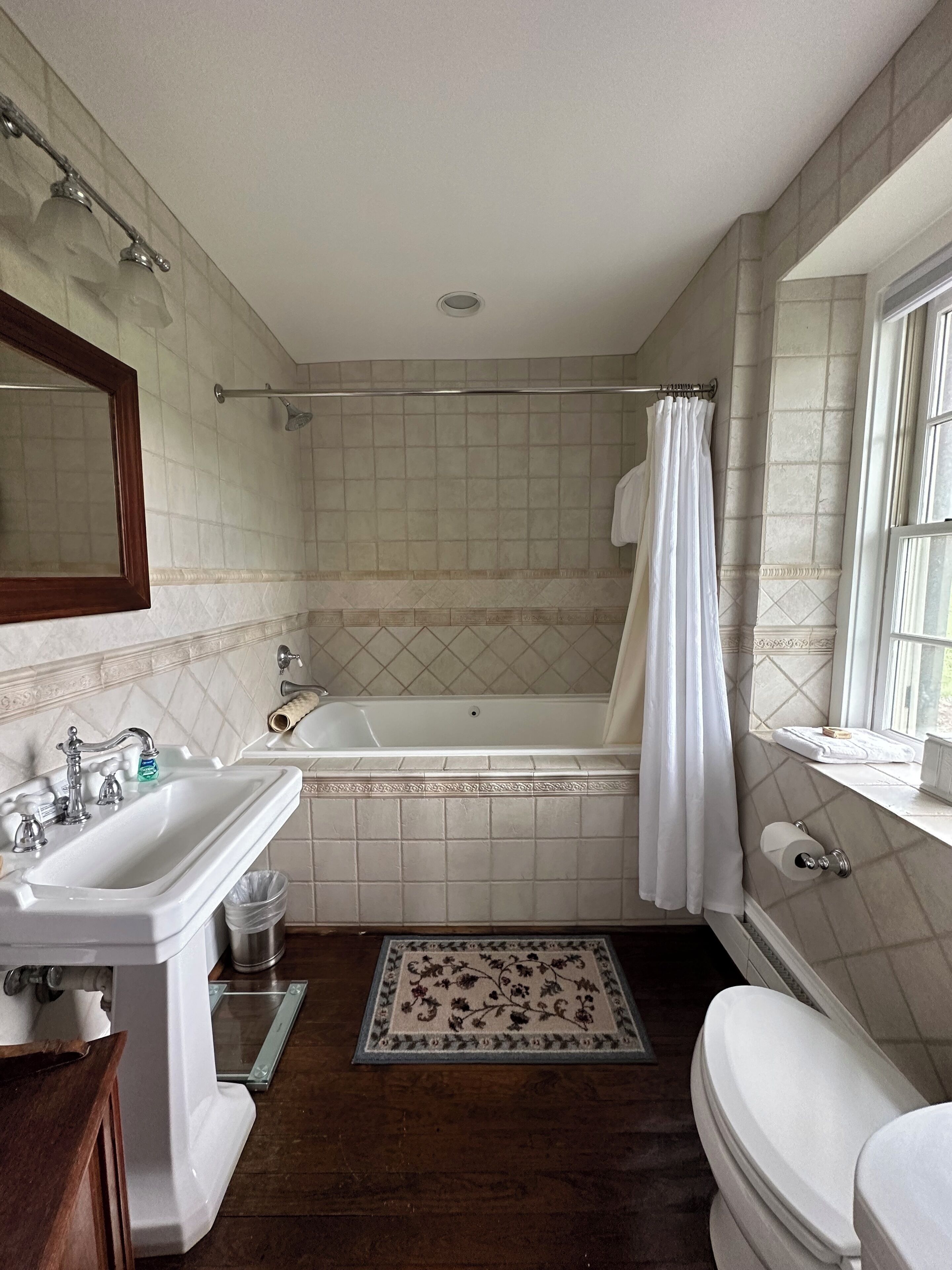 A bathroom with a sink, toilet, bathtub, and shower.