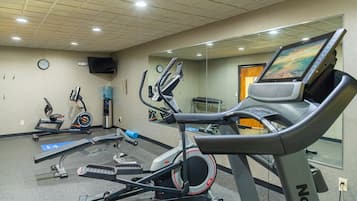 A gym with stationary bikes, treadmills, and exercise equipment.