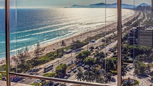 A coastal cityscape with a beach, roads, and buildings.