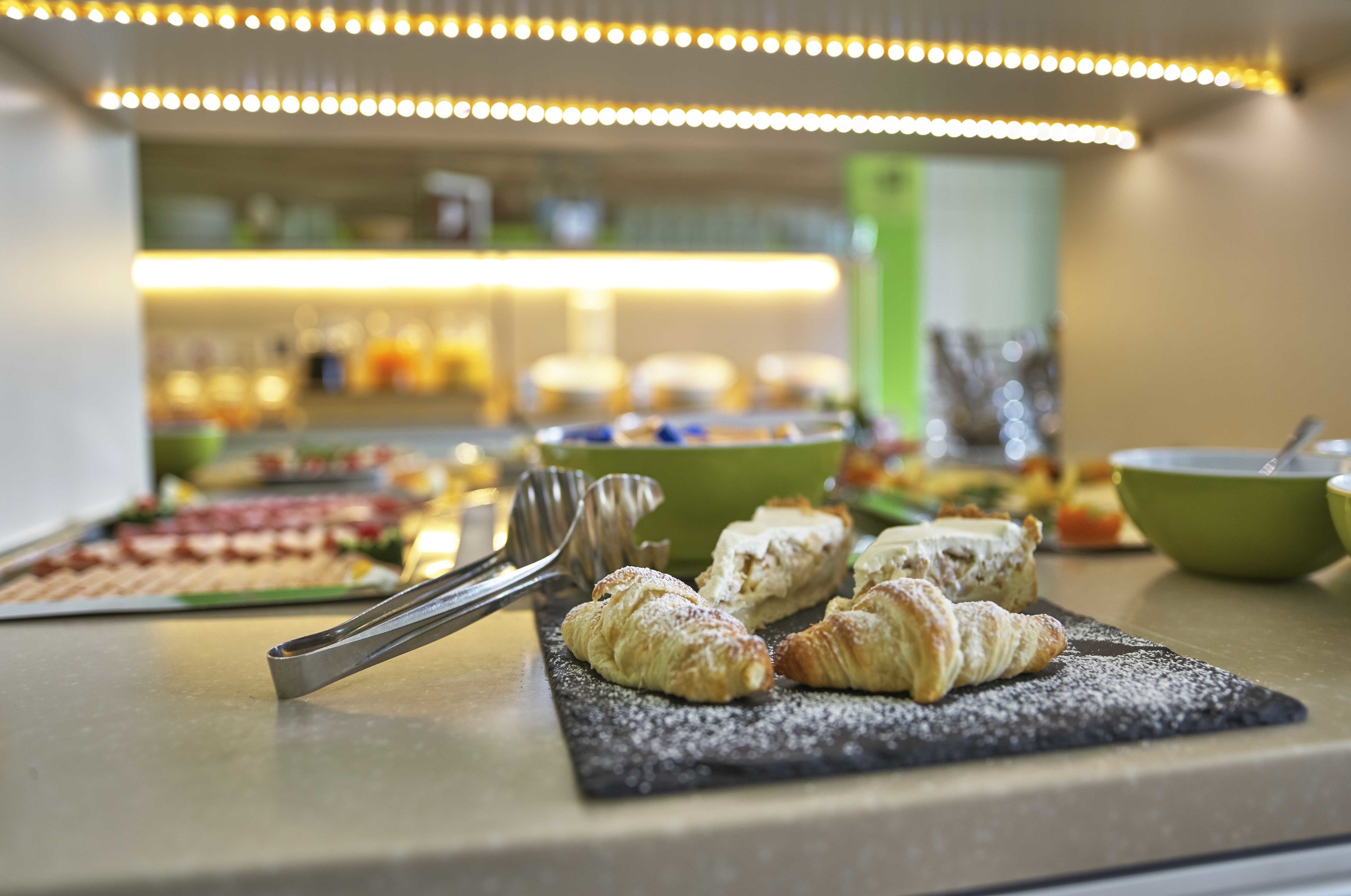 A buffet with pastries and a variety of dishes.