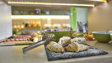 A buffet with pastries and a variety of dishes.