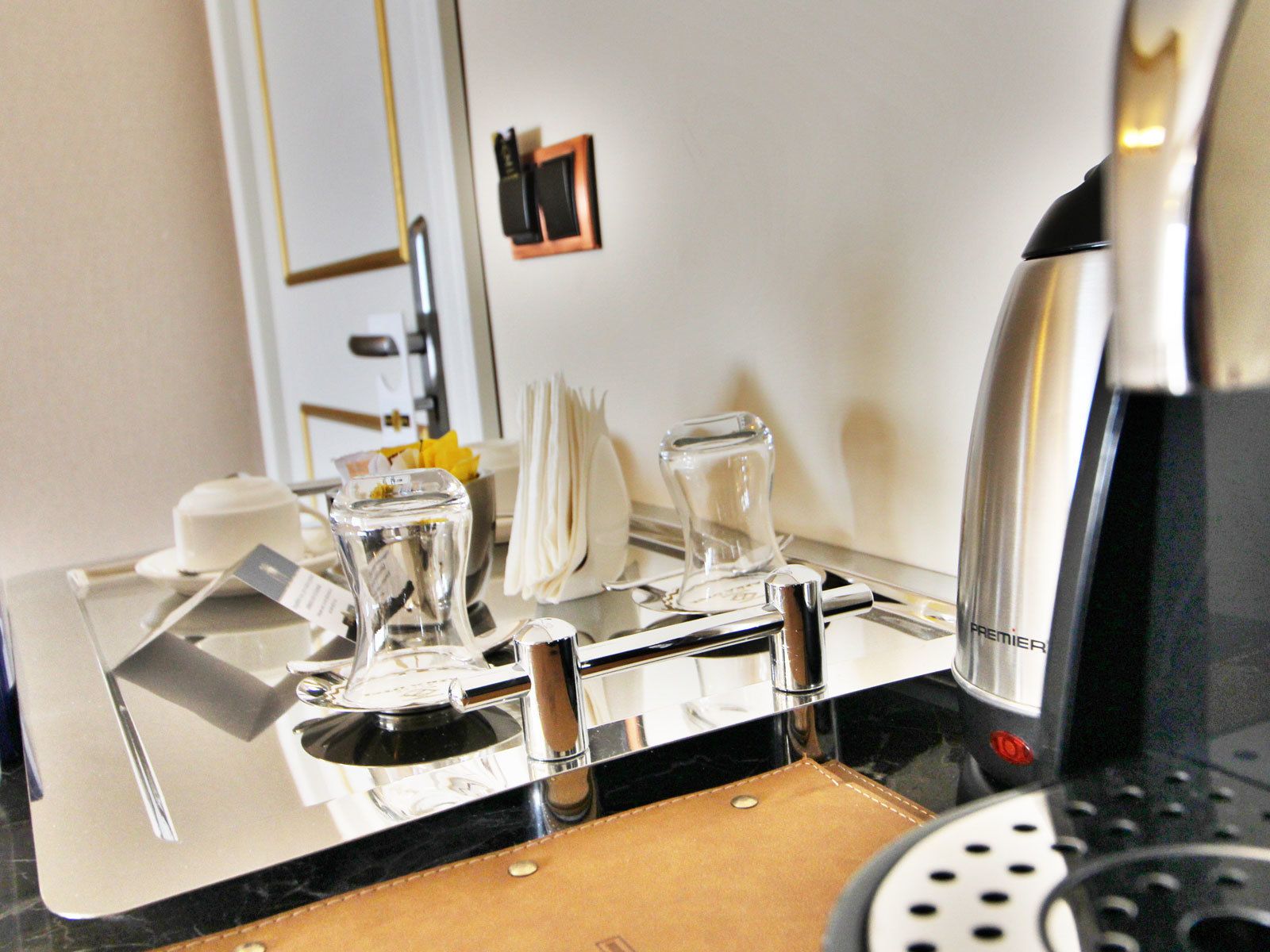 A modern kitchen with stainless steel appliances, a coffee maker, and a kettle.