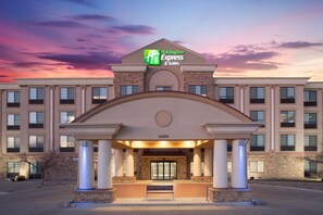 A Holiday Inn Express & Suites building with a classic architectural design, featuring a prominent entrance with columns and a large glass door. - Holiday Inn Express Hotel & Suites Ft. Collins by IHG (Fort Collins)