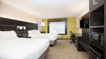 A hotel room with two beds, a desk, a chair, a television, and a microwave.