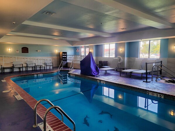 A swimming pool with diving boards, lounge chairs, and a covered seating area. - Holiday Inn Express Hotel & Suites Enid - Highway 412 by IHG (Enid)