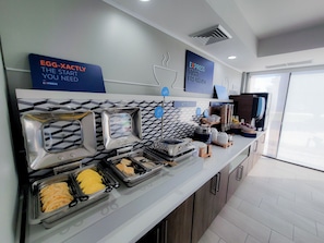 A breakfast buffet with labeled sections for hot food, cereal, and beverages. - Holiday Inn Express Hotel & Suites Enid - Highway 412 by IHG (Enid)