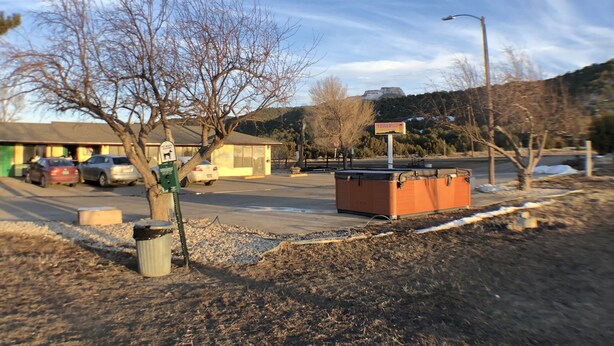 A parking lot with cars, a building, and a sign that reads "TOWER 24". - Tower 64 Motel & RV Park (Trinidad)