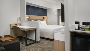 A hotel room with a bed, a desk, a chair, a coffee machine, and a tray table. - SpringHill Suites by Marriott Annapolis (Annapolis)