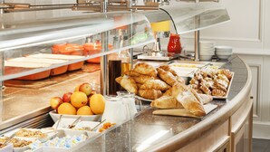 A buffet with various food items including fruits, pastries, and beverages. - Mercure Birmingham West Hotel (West Bromwich)