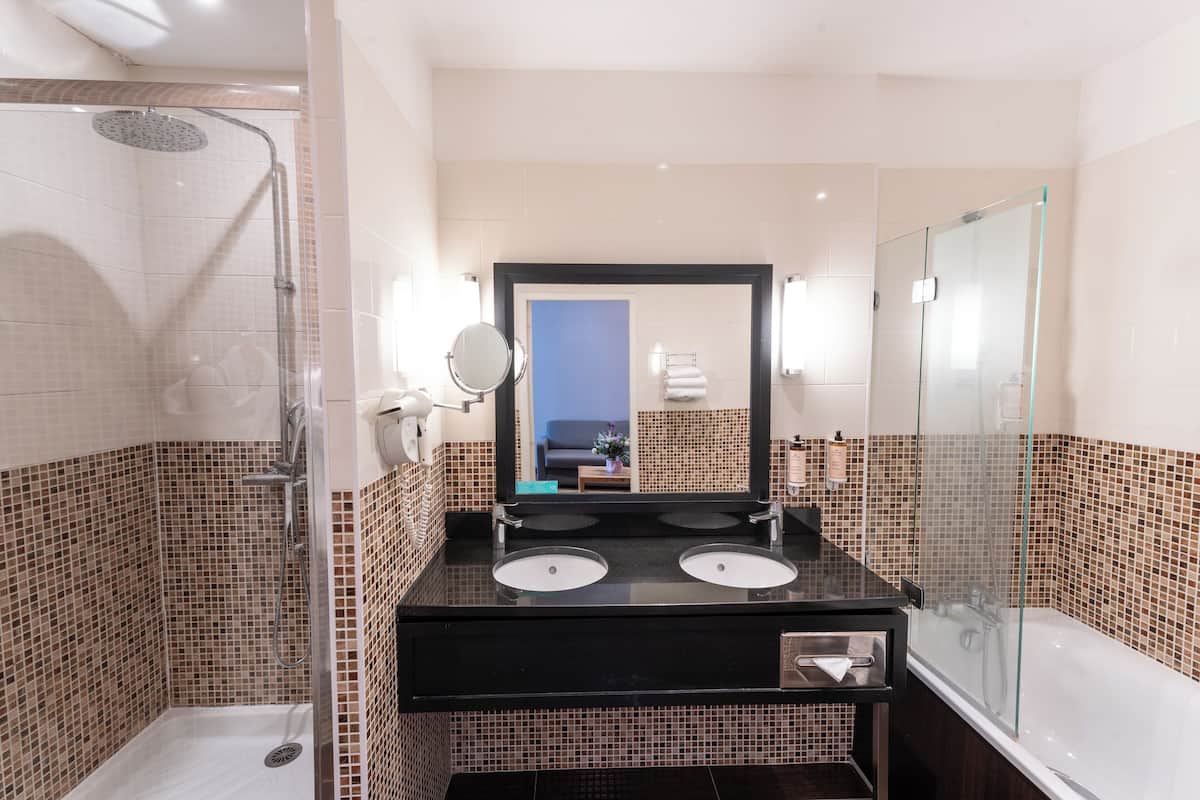 suite, 1 king bed | bathroom | eco-friendly toiletries, hair dryer, towels