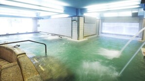 A large indoor pool with a wooden bench and a metal railing. - Prince Hotel (Jiaoxi)