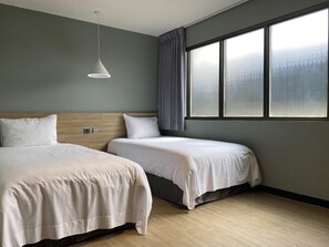 A hotel room with two beds, a wooden headboard, a large window with curtains, and a hanging light fixture. - Prince Hotel (Jiaoxi)