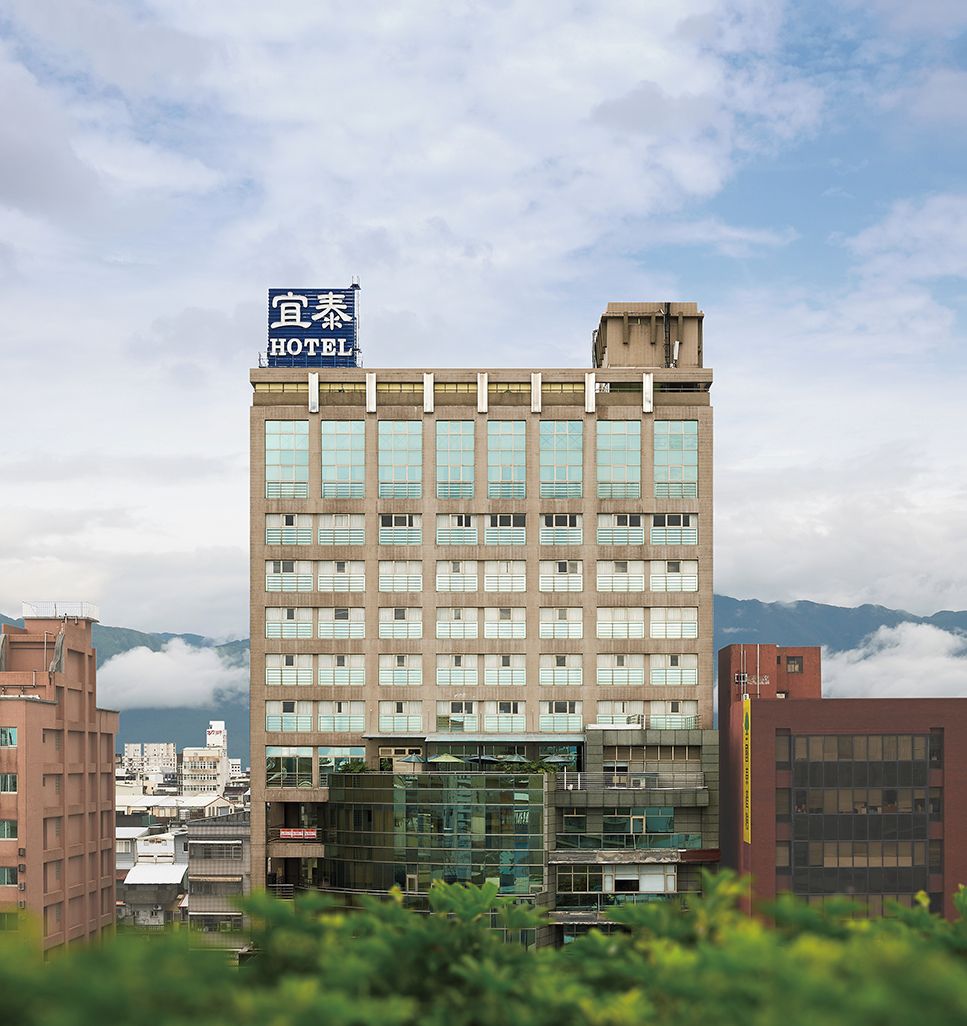 A multi-story hotel building with a sign indicating it is a hotel.