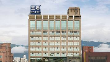 A multi-story hotel building with a sign indicating it is a hotel.