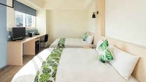 A hotel room with two beds, a desk with a computer, and a window with a city view. - Liga Hotel (Hualien City)