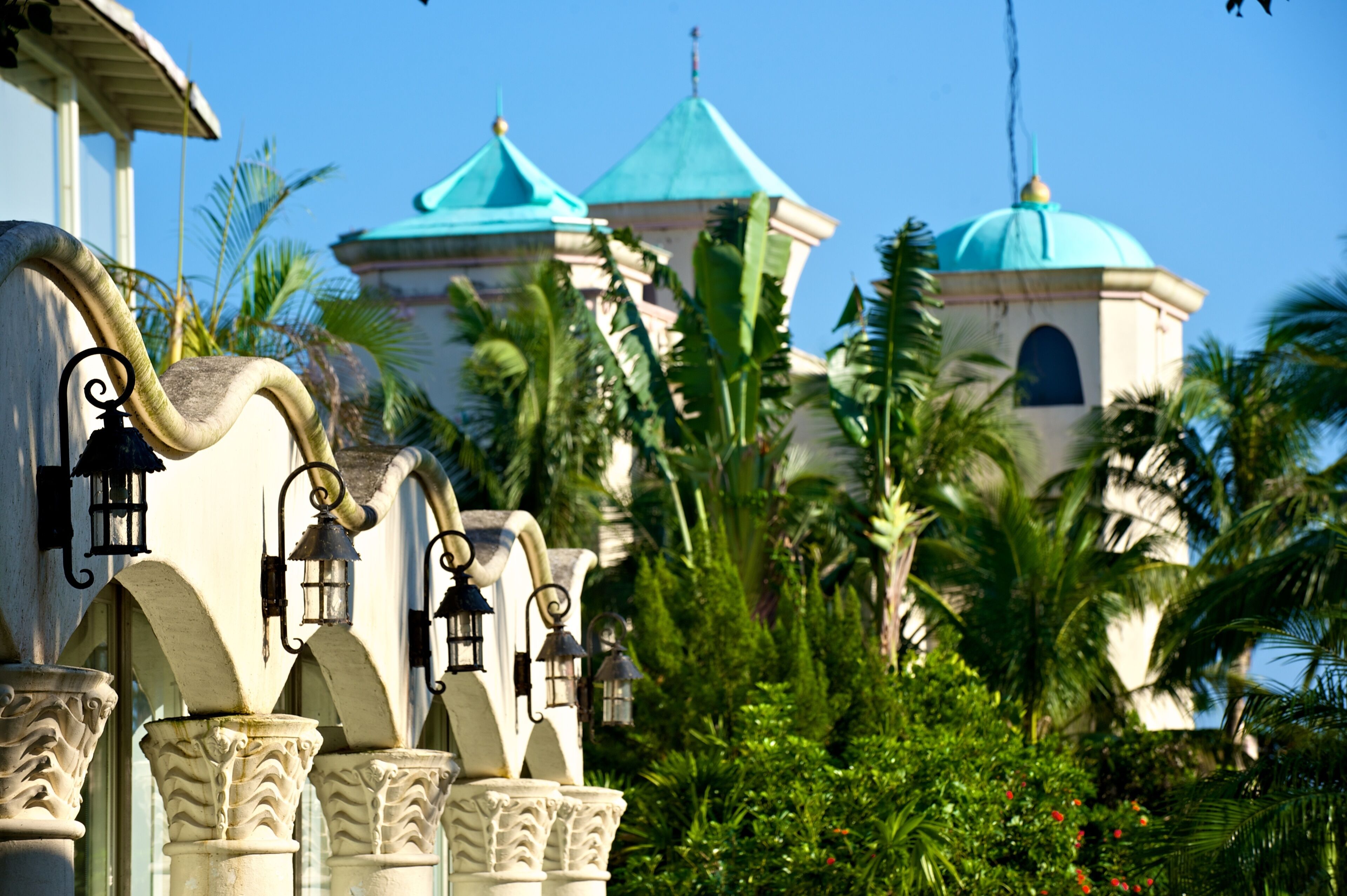 A building with a curved facade, multiple arches, and a series of lanterns.
