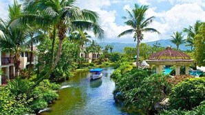A tropical resort with a waterway, palm trees, and a gazebo. - Promisedland Resort & Lagoon (Shoufeng)