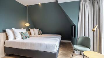 Une chambre à coucher moderne avec un grand lit, une chaise et une petite table.
