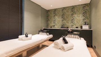 Relax in a serene spa room with two treatment beds and a comfortable bench.