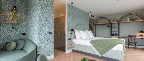 Un dormitorio moderno con cama, sofá, escritorio y silla.