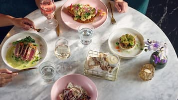 A table with various dishes and drinks, suggesting a dining setting.