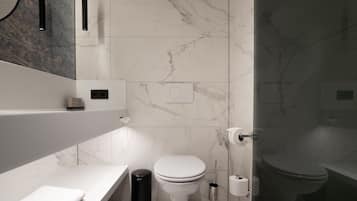 A modern bathroom with a white toilet, a sink, and a mirror.
