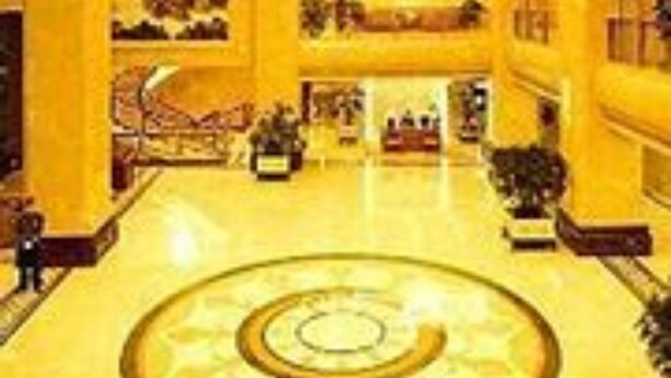 A grand lobby with a central circular floor design, multiple levels, and a chandelier. - XinHai JinJiang Hotel Wangfujing (Beijing)