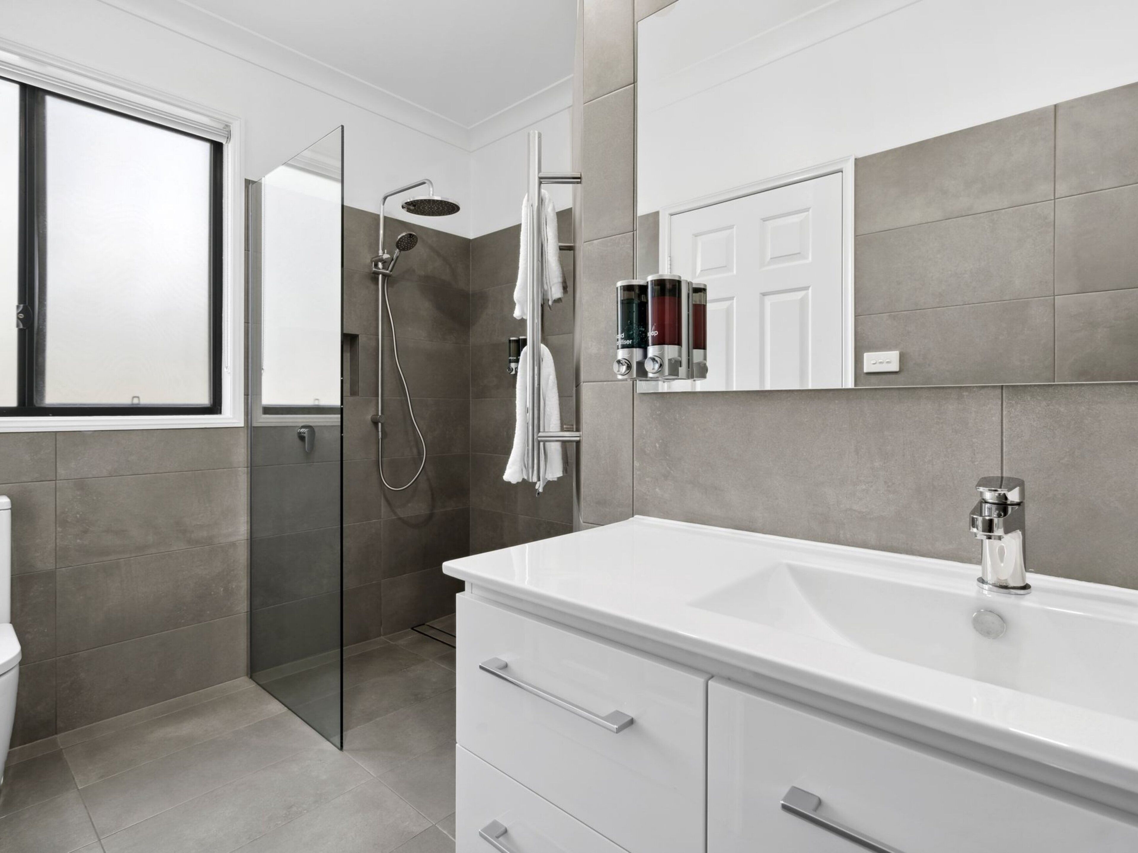 two-bedroom king and queen apartment | bathroom | combined shower/bathtub, jetted bath, hair dryer, towels