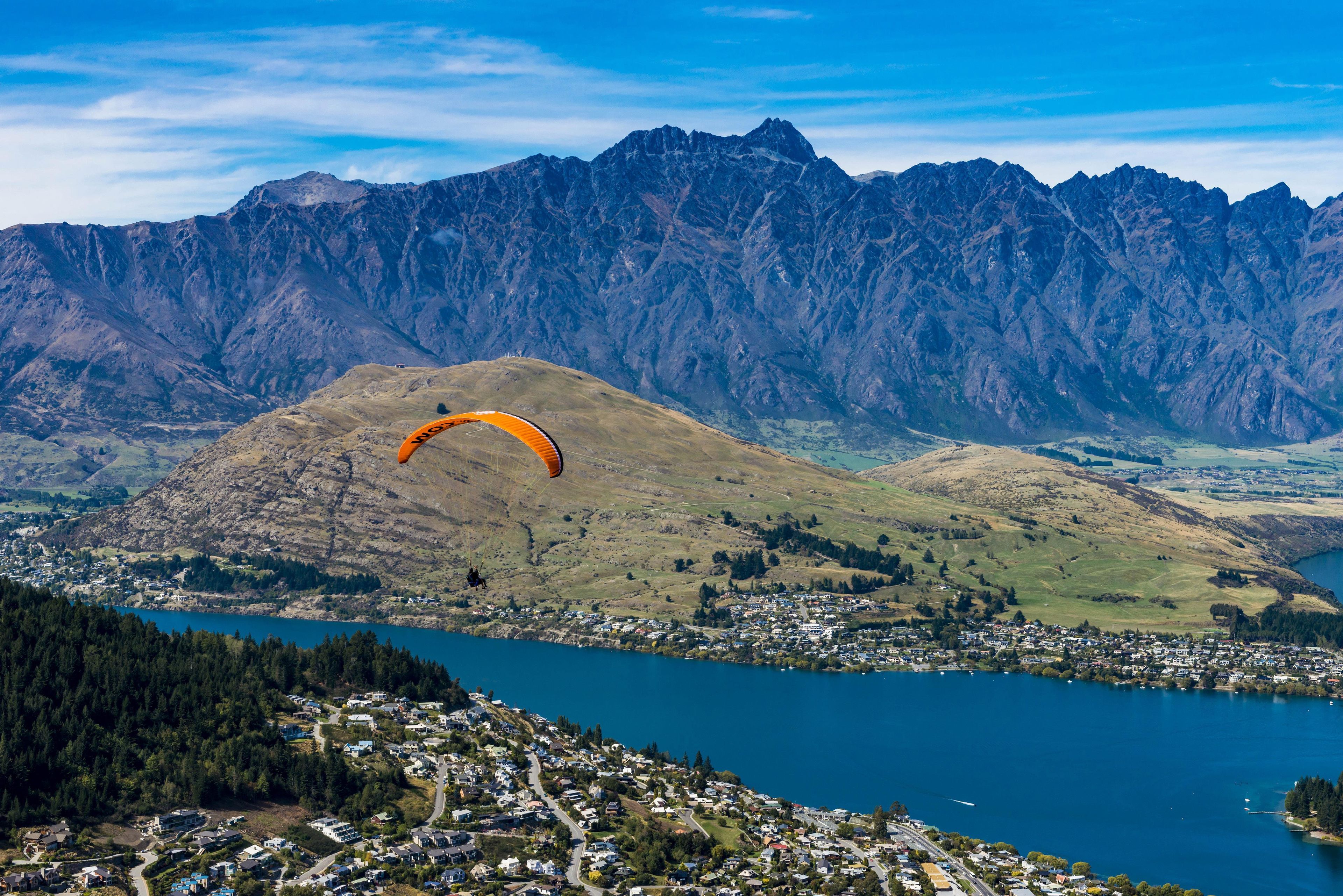 A mountainous landscape with a lake and a town below.