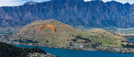 A mountainous landscape with a lake and a town below.