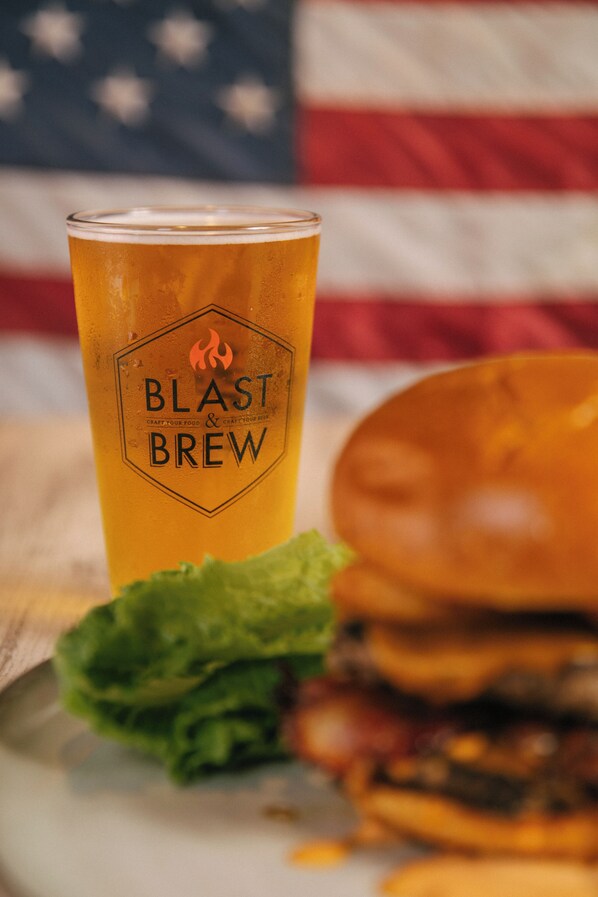 A glass of beer with a label reading "BLAST BREW" and a burger with lettuce and a bun. - SeaCrest OceanFront Hotel (Pismo Beach)