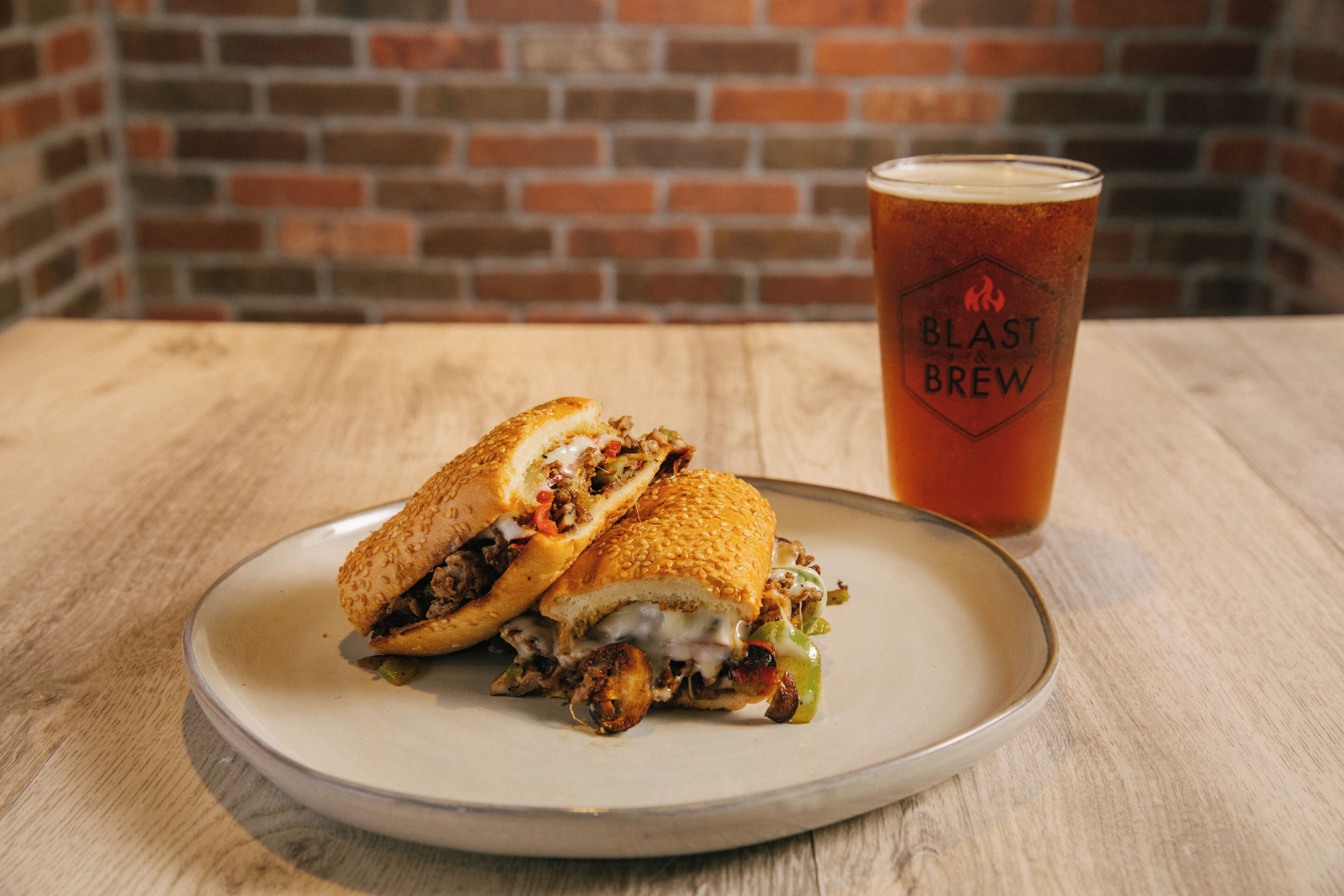 A sandwich and a glass of beer on a plate.